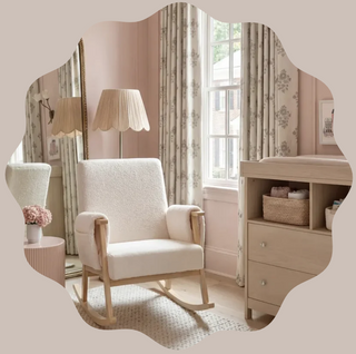 Rocking chair in front of window with curtains, lamp, mirror, and a storage unit holding baskets.